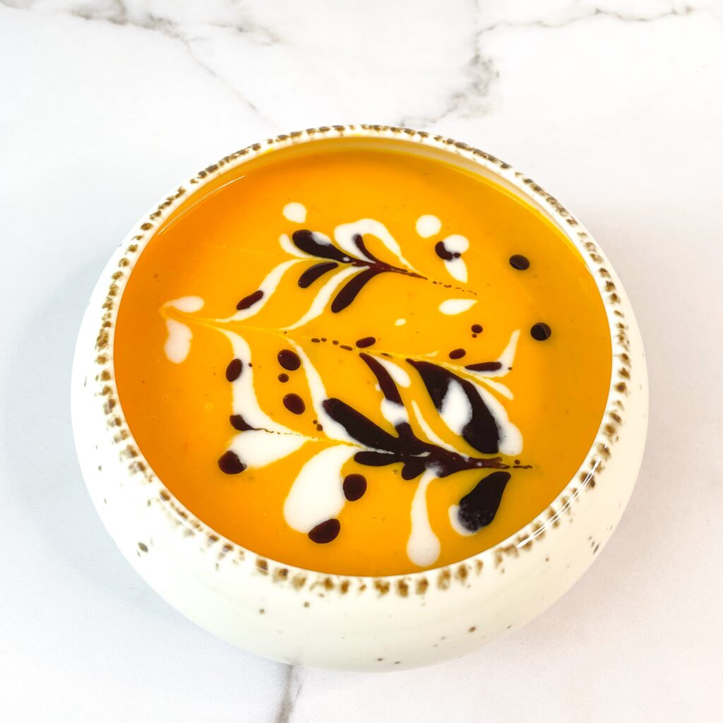 easy-vegan-pumpkin-soup-garnished-with-pumpkinseed-oil-and-coconut-cream_I_